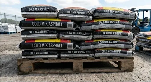 Stacked Cold Mix Asphalt 25kg bags on pallet — use our coverage calculator to work out how many bags you need
